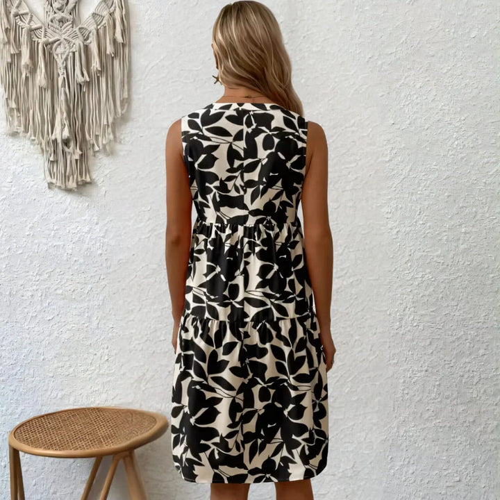 Black sleeveless summer dress with V-neck on the model