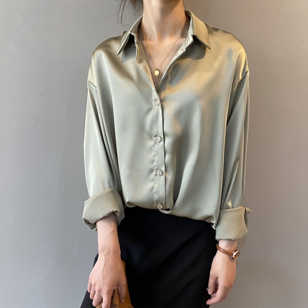 Green loose satin blouse on the model