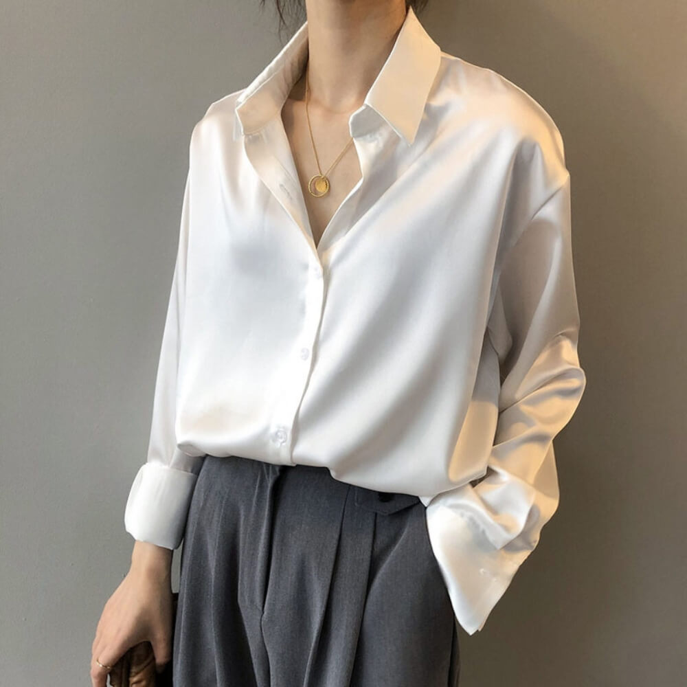 White loose satin blouse on the model