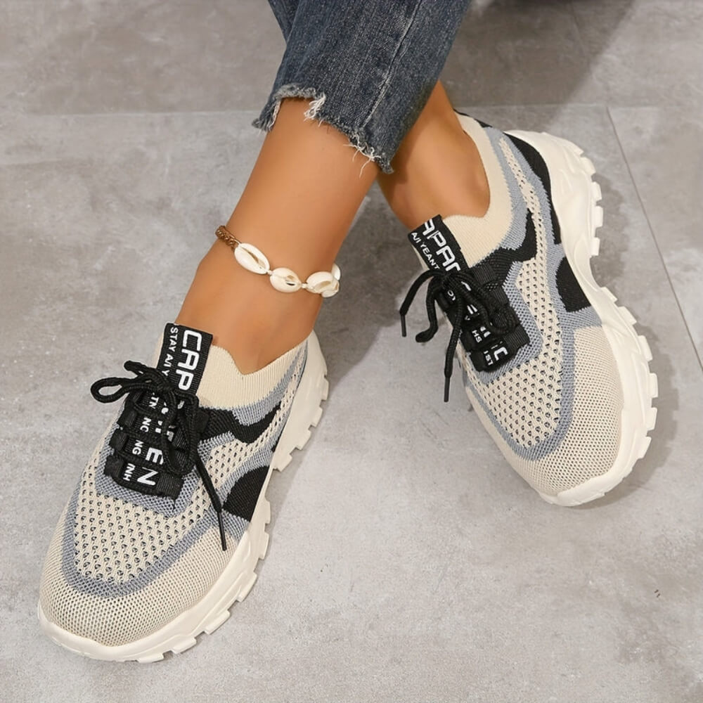 Beige orthopaedic breathable trainers on model