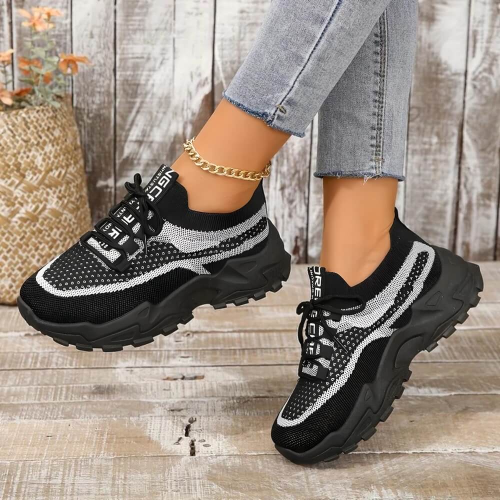 Black orthopaedic breathable trainers on model