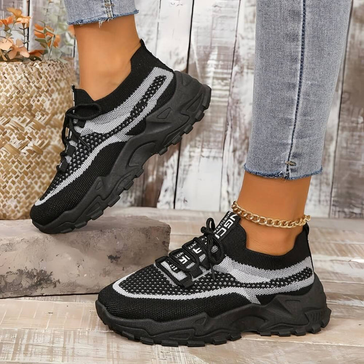 Black orthopaedic breathable trainers on model